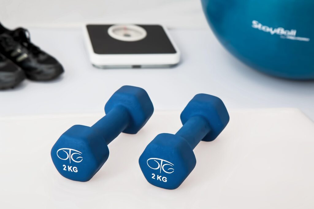 Two 2kg dumbbells on a gym floor, symbolizing strength training and fitness—used to illustrate common myths in physical fitness.