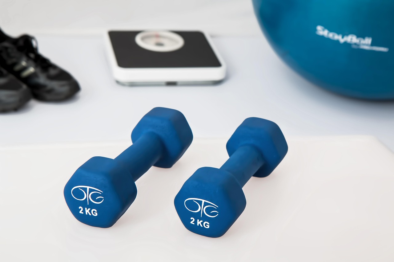 Two 2kg dumbbells on a gym floor, symbolizing strength training and fitness—used to illustrate common myths in physical fitness.