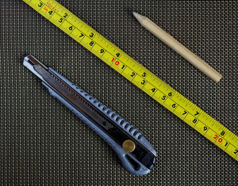 Basic DIY tools like a tape measure, pencil, and craft knife used in setting up a STEM learning environment at home.