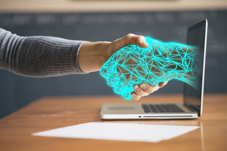 A close-up shot of hands making an "OK" gesture in front of digital technology, symbolizing the connection between STEM and technology in fitness teaching.